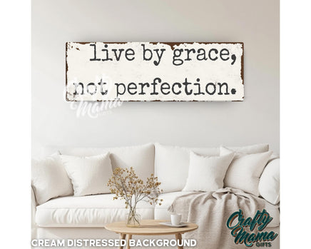 a wooden sign that says live by grace, not perfection